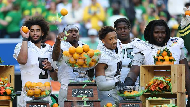 Oregon Ducks quarterback Dante Moore (5), wide receiver Malik Benson (4), defensive back Brandon Finney (4) and defensive lineman Bear Alexander (1) celebrate following the 2025 Orange Bowl and quarterfinal game of the College Football Playoff against the Texas Tech Red Raiders at Hard Rock Stadium.