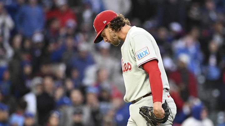 Apr 20, 2026; Chicago, Illinois, USA;  Philadelphia Phillies pitcher Aaron Nola (27) looks down after Chicago Cubs shortstop Dansby Swanson (not pictured) hits a three run home during the second inning at Wrigley Field. Mandatory Credit: Matt Marton-Imagn Images