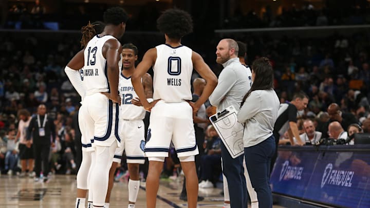 Dec 5, 2024; Memphis, Tennessee, USA; Memphis Grizzlies head coach Taylor Jenkins (right) huddles with his team during a time out during the second quarter at FedExForum. Mandatory Credit: Petre Thomas-Imagn Images