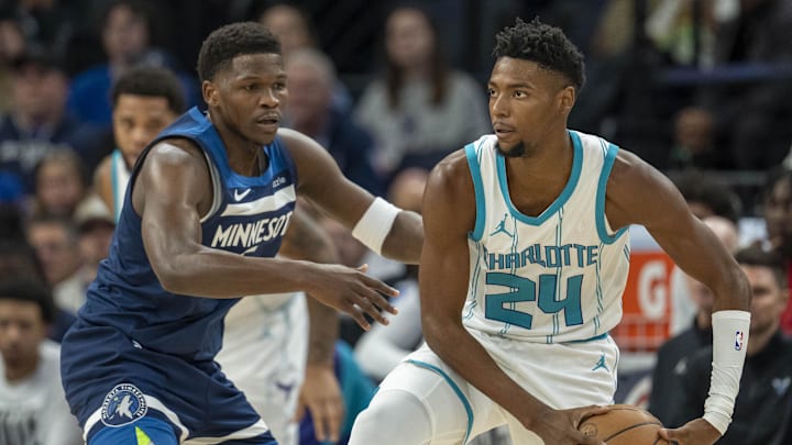 Nov 4, 2024; Minneapolis, Minnesota, USA; Charlotte Hornets forward Brandon Miller (24) looks to pass the ball past Minnesota Timberwolves guard Anthony Edwards (5) in the first half at Target Center. Mandatory Credit: Jesse Johnson-Imagn Images