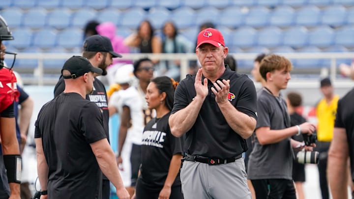Dec 23, 2025; Boca Raton, FL, USA; Louisville Cardinals head coach Jeff Brohm watches his team warm up before the Boca Raton Bowl against the Toledo Rockets at Flagler CU Stadium. Mandatory Credit: Jeff Romance-Imagn Images