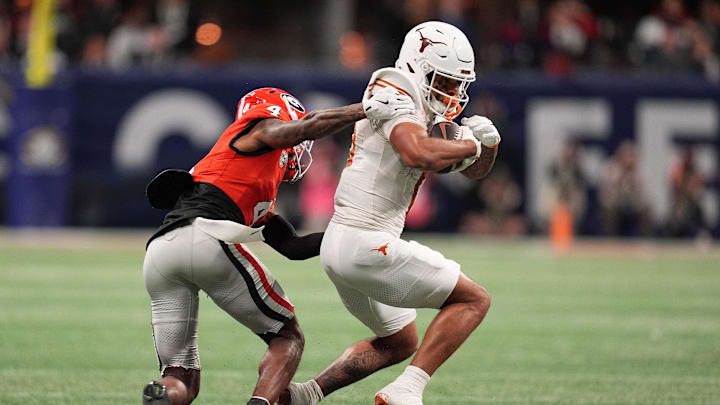 Dec 7, 2024; Atlanta, GA, USA; Georgia Bulldogs defensive back KJ Bolden (4) makes a tackle on Texas Longhorns wide receiver DeAndre Moore Jr. (0) during the first half in the 2024 SEC Championship game at Mercedes-Benz Stadium. Mandatory Credit: Dale Zanine-Imagn Images