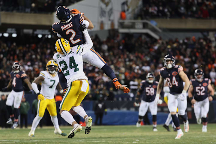Chicago Bears wide receiver DJ Moore (2) leaps to catch a pass against Green Bay Packers cornerback Carrington Valentine.
