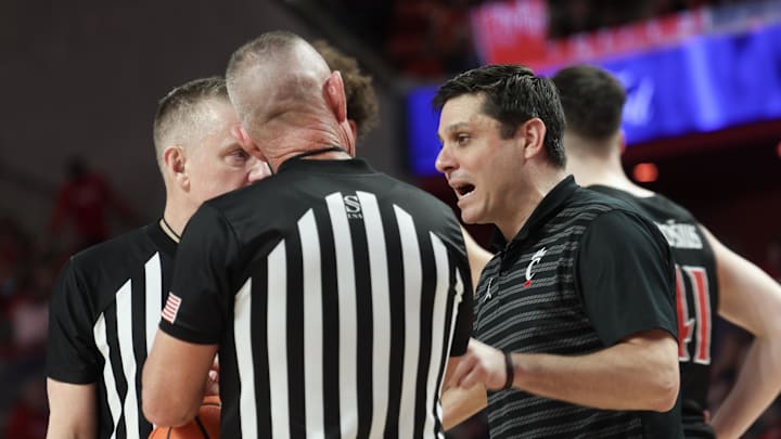 Mar 1, 2025; Houston, Texas, USA; Cincinnati Bearcats head coach Wes Miller talks with officials during a Houston Cougars timeout  in the first half at Fertitta Center. Mandatory Credit: Thomas Shea-Imagn Images