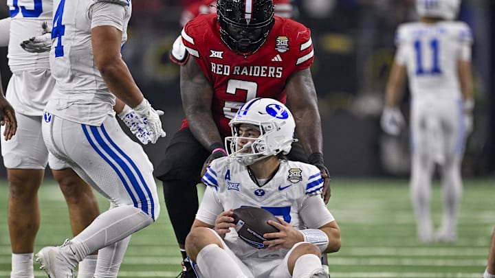Dec 6, 2025; Arlington, TX, USA; Texas Tech Red Raiders defensive lineman Lee Hunter (2) helps up BYU Cougars quarterback Bear Bachmeier (47) during the game between the Red Raiders and the Cougars at AT&T Stadium. Mandatory Credit: Jerome Miron-Imagn Images