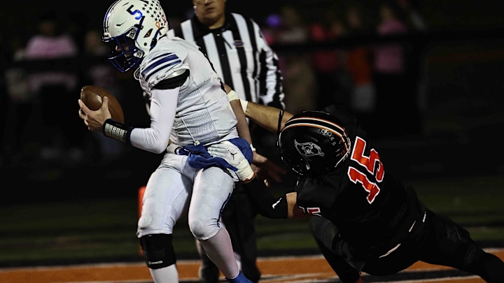 Ryle's Bo Gay (15) sacks Simon Kenton quarterback Grant Webb (5) during their football game Friday, Oct. 24, 2025, at Ryle High School.