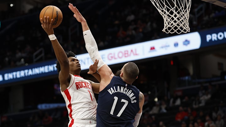 Jan 7, 2025; Washington, District of Columbia, USA; Houston Rockets forward Amen Thompson (1) shoots the ball as Washington Wizards center Jonas Valanciunas (17) defends in the third quarter at Capital One Arena. Mandatory Credit: Geoff Burke-Imagn Images