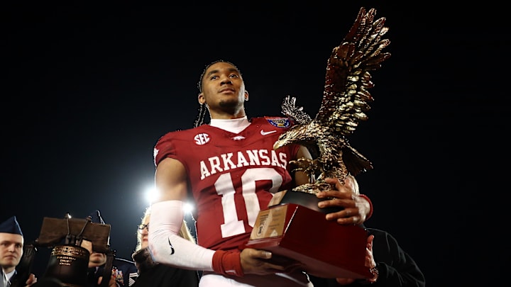 Arkansas Razorbacks quarterback Taylen Green (10) holds the AutoZone Liberty Bowl MVP trophy after defeating against the Texas Tech Red Raiders at Simmons Bank Liberty Stadium.