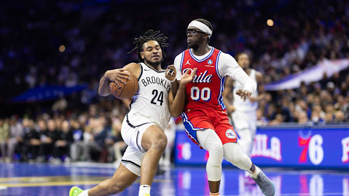 Nov 22, 2024; Philadelphia, Pennsylvania, USA; Brooklyn Nets guard Cam Thomas (24) drives against Philadelphia 76ers guard Reggie Jackson (00) during the second quarter at Wells Fargo Center. Mandatory Credit: Bill Streicher-Imagn Images