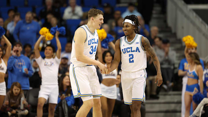 Jan 21, 2025; Los Angeles, California, USA;  UCLA Bruins guard Dylan Andrews (2) is greeted by forward Tyler Bilodeau (34) during the second half against the Wisconsin Badgers at Pauley Pavilion presented by Wescom. Mandatory Credit: Kiyoshi Mio-Imagn Images
