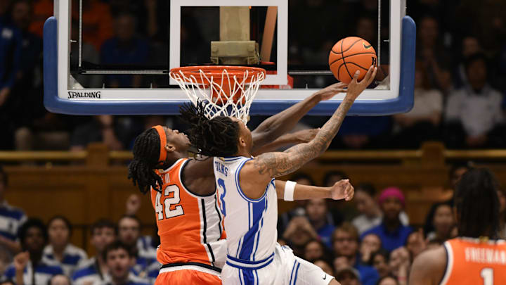Feb 16, 2026; Durham, North Carolina, USA; Duke Blue Devils guard Isaiah Evans (3) attempts a layup against Syracuse Orange forward William Kyle (42) during the during the first half at Cameron Indoor Stadium. Mandatory Credit: Zachary Taft-Imagn Images Feb 16, 2026; Durham, North Carolina, USA; Duke Blue Devils guard Isaiah Evans (3) attempts a layup against Syracuse Orange forward William Kyle (42) during the during the first half at Cameron Indoor Stadium. Mandatory Credit: Zachary Taft-Imagn Images
