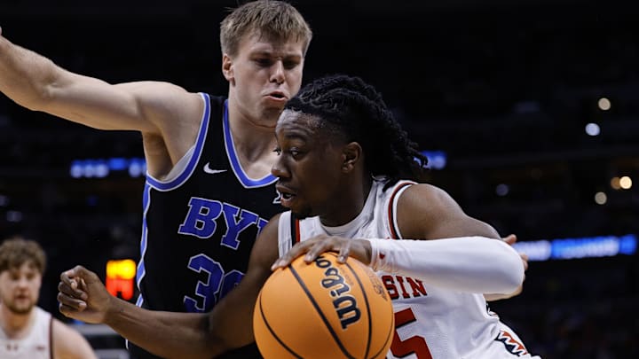 Mar 22, 2025; Denver, CO, USA; Wisconsin Badgers guard John Blackwell (25) dribbles the ball against the Brigham Young Cougars during the first half in the second round of the NCAA Tournament at Ball Arena.