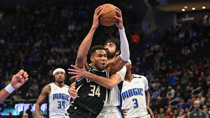 Dec 10, 2024; Milwaukee, Wisconsin, USA; Milwaukee Bucks forward Giannis Antetokounmpo (34) is fouled by Orlando Magic center Goga Bitadze (35) in the second quarter at Fiserv Forum. Mandatory Credit: Benny Sieu-Imagn Images