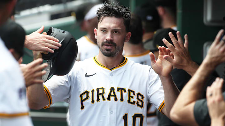 Jun 29, 2025; Pittsburgh, Pennsylvania, USA;  Pittsburgh Pirates right fielder Bryan Reynolds (10) high-fives in the dugout after scoring a run against the New York Mets during first inning at PNC Park. 