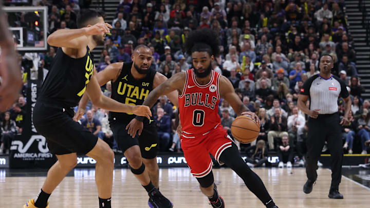 Mar 6, 2024; Salt Lake City, Utah, USA; Chicago Bulls guard Coby White (0) dribbles past Utah Jazz guard Talen Horton-Tucker (5) during the third quarter at Delta Center. Mandatory Credit: Rob Gray-Imagn Images