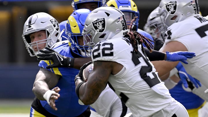 Oct 20, 2024; Inglewood, California, USA; Las Vegas Raiders running back Alexander Mattison (22) runs the ball against Los Angeles Rams linebacker Jared Verse (8) during the first half at SoFi Stadium. Mandatory Credit: Alex Gallardo-Imagn Images
