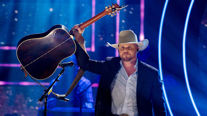 Cody Johnson lifts his guitar to the crowd after his performance during the CMT Artists of the Year event at the Nashville Symphony’s Schermerhorn Symphony Center in Nashville on Oct. 12, 2022.