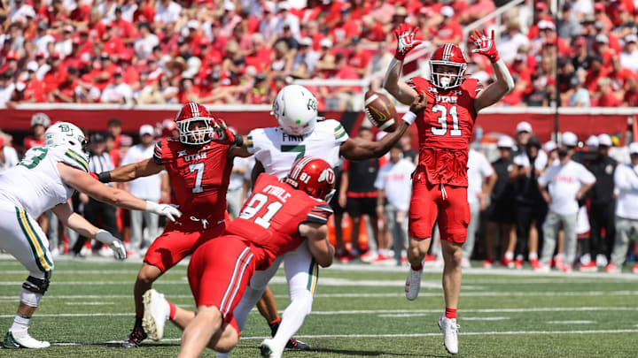Sep 7, 2024; Salt Lake City, Utah, USA; Utah Utes defensive tackle Jonah Lea'ea (91) forces a fumble by Baylor Bears quarterback Dequan Finn (7) during the first quarter at Rice-Eccles Stadium. Mandatory Credit: Rob Gray-Imagn Images