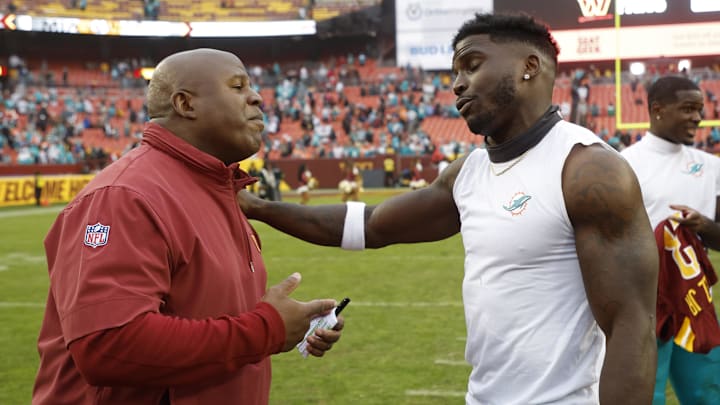 Dec 3, 2023; Landover, Maryland, USA; Miami Dolphins wide receiver Tyreek Hill (R) hugs Washington Commanders assistant head coach/offensive coordinator Eric Bieniemy (L) at FedExField. Mandatory Credit: Geoff Burke-Imagn Images Dec 3, 2023; Landover, Maryland, USA; Miami Dolphins wide receiver Tyreek Hill (R) hugs Washington Commanders assistant head coach/offensive coordinator Eric Bieniemy (L) at FedExField. Mandatory Credit: Geoff Burke-Imagn Images