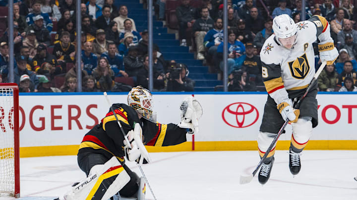 Apr 6, 2025; Vancouver, British Columbia, CAN; Vancouver Canucks goalie Kevin Lankinen (32) makes a save behind leaping Vegas Golden Knights forward Jack Eichel (9) in the third period at Rogers Arena. Mandatory Credit: Bob Frid-Imagn Images