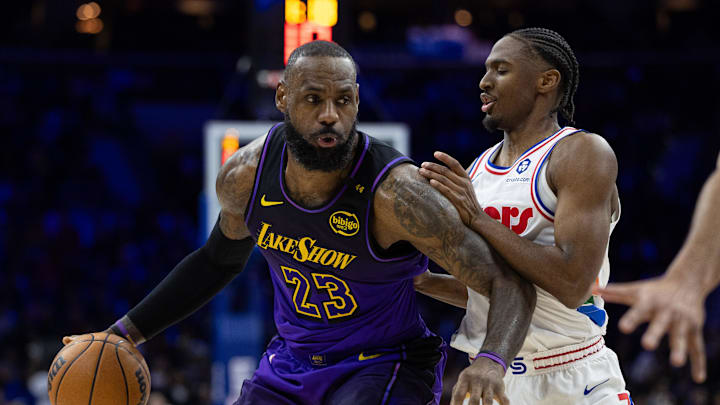 Jan 28, 2025; Philadelphia, Pennsylvania, USA; Los Angeles Lakers forward LeBron James (23) controls the ball against Philadelphia 76ers guard Tyrese Maxey (0) during the second quarter at Wells Fargo Center. Mandatory Credit: Bill Streicher-Imagn Images
