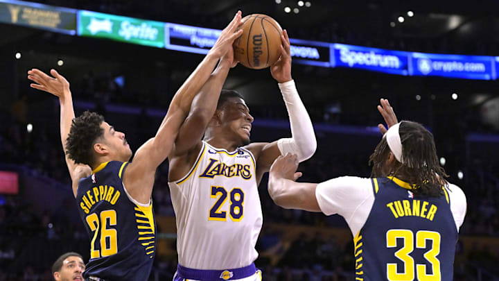 Mar 24, 2024; Los Angeles, California, USA;   Los Angeles Lakers forward Rui Hachimura (28) is defended by Indiana Pacers guard Ben Sheppard (26) and center Myles Turner (33) in the second half at Crypto.com Arena. Mandatory Credit: Jayne Kamin-Oncea-Imagn Images