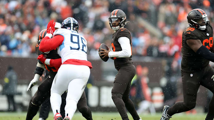Dec 7, 2025; Cleveland, Ohio, USA; Cleveland Browns quarterback Shedeur Sanders (12) looks to throw a pass against Tennessee Titans defensive tackle Jeffery Simmons (98) during the first quarter at Huntington Bank Field. Mandatory Credit: Scott Galvin-Imagn Images