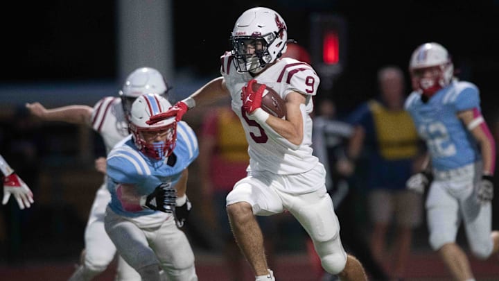 Seaman junior Kaden McKinney runs the ball during a play in the first quarter of the game against Shawnee Heights on Friday, October 11, 2024, at Shawnee Heights High School.