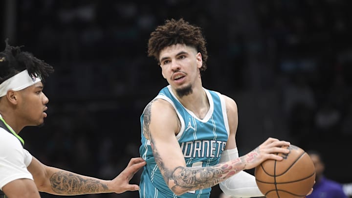 Mar 5, 2025; Charlotte, North Carolina, USA; Charlotte Hornets guard LaMelo Ball (1) controls the ball as he is defended by Minnesota Timberwolves guard Terrence Shannon Jr. (00) during the first half at the Spectrum Center. Mandatory Credit: Sam Sharpe-Imagn Images Mar 5, 2025; Charlotte, North Carolina, USA; Charlotte Hornets guard LaMelo Ball (1) controls the ball as he is defended by Minnesota Timberwolves guard Terrence Shannon Jr. (00) during the first half at the Spectrum Center. Mandatory Credit: Sam Sharpe-Imagn Images