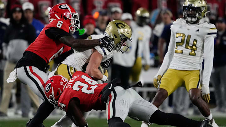 Georgia defensive back Daylen Everette (6) and Georgia defensive back Malaki Starks (24) stop Georgia Tech wide receiver Bailey Stockton (87) during the first half of a NCAA college football game against Georgia Tech in Athens, Ga., on Friday, Nov. 29, 2024.