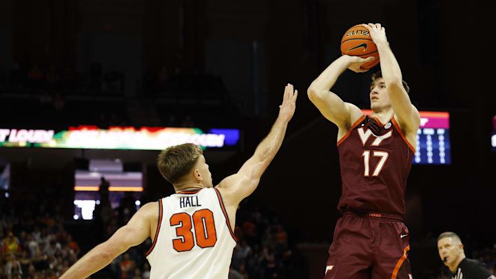 Mar 7, 2026; Charlottesville, Virginia, USA; Virginia Tech Hokies guard Neoklis Avdalas (17) shoots the ball as Virginia Cavaliers guard Dallin Hall (30) defends in the first half at John Paul Jones Arena. Mandatory Credit: Geoff Burke-Imagn Images