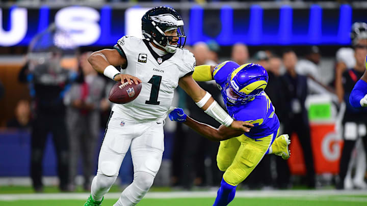 Nov 24, 2024; Inglewood, California, USA; Philadelphia Eagles quarterback Jalen Hurts (1) runs the ball against Los Angeles Rams safety Quentin Lake (37) during the first half at SoFi Stadium. Mandatory Credit: Gary A. Vasquez-Imagn Images