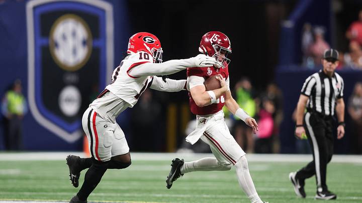 Dec 6, 2025; Atlanta, GA, USA; Alabama Crimson Tide quarterback Ty Simpson (15) scrambles and is tackled by Georgia Bulldogs linebacker Zayden Walker (10) during the fourth quarter during the 2025 SEC Championship game at Mercedes-Benz Stadium. Mandatory Credit: Brett Davis-Imagn Images
