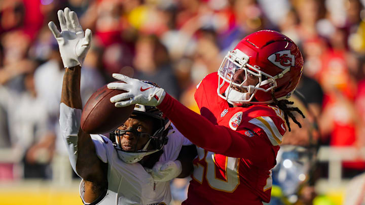 Sep 28, 2025; Kansas City, Missouri, USA; Kansas City Chiefs cornerback Nohl Williams (20) breaks up a pass intended for Baltimore Ravens wide receiver Deandre Hopkins (10) during the first half at GEHA Field at Arrowhead Stadium. Mandatory Credit: Jay Biggerstaff-Imagn Images