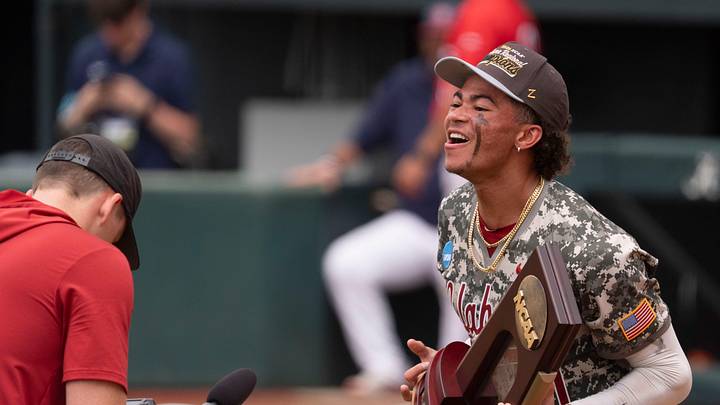 Jun 8, 2026; Tuscaloosa, AL, USA; The Crimson Tide players and coaches celebrate their 7-2 win over St. John’s to earn a trip to the College World Series. Alabama shortstop Justin Lebron (1) brings the Super Regional Trophy back to the team. Jun 8, 2026; Tuscaloosa, AL, USA; The Crimson Tide players and coaches celebrate their 7-2 win over St. John’s to earn a trip to the College World Series. Alabama shortstop Justin Lebron (1) brings the Super Regional Trophy back to the team.