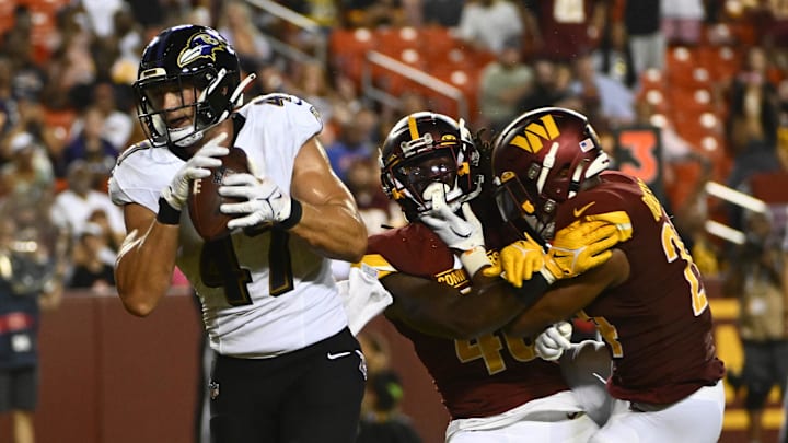 Aug 21, 2023; Landover, Maryland, USA; Baltimore Ravens tight end Travis Vokolek (47) scores a touchdown  against the Washington Commanders during the second half at FedExField. Mandatory Credit: Brad Mills-Imagn Images