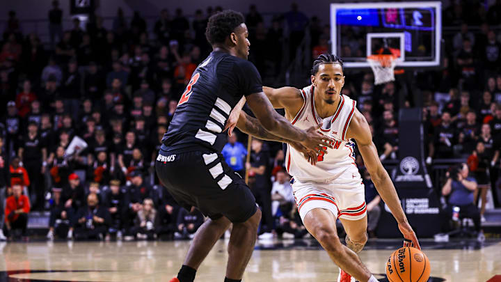 Jan 3, 2026; Cincinnati, Ohio, USA; Houston Cougars guard Milos Uzan (7) dribbles against Cincinnati Bearcats guard Jizzle James (2) in the first half at Fifth Third Arena. Mandatory Credit: Katie Stratman-Imagn Images