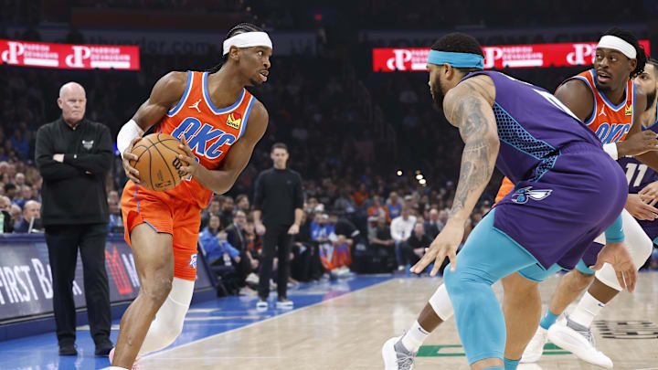 Feb 2, 2024; Oklahoma City, Oklahoma, USA; Oklahoma City Thunder guard Shai Gilgeous-Alexander (2) moves the ball on a drive against Charlotte Hornets forward Miles Bridges (0) during the first quarter at Paycom Center. Mandatory Credit: Alonzo Adams-Imagn Images