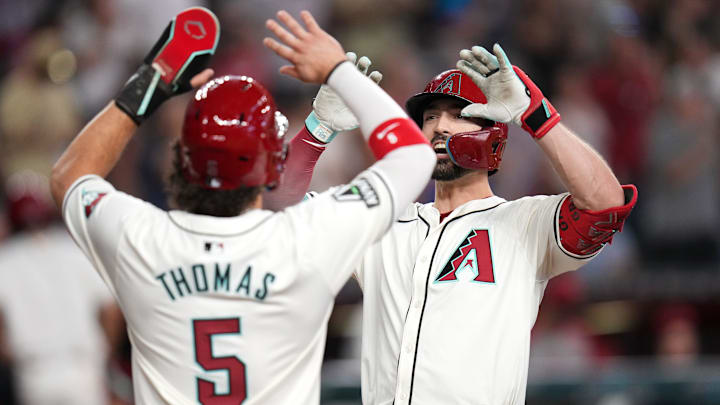 Arizona Diamondbacks Randal Grichuk (15) high-fives teammate Alek Thomas (5) after his 2-run home run against the San Diego Padres at Chase Field on Sept. 29, 2024, in Phoenix.