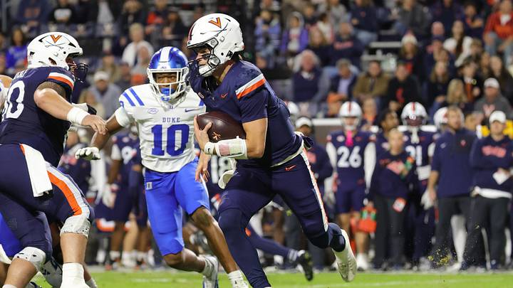 Oct 23, 2026; Charlottesville, Virginia, USA; Virginia Cavaliers quarterback Beau Pribula (7) runs with the ball past Duke Blue Devils defensive end Tyshon Reed (10) during the first half at Scott Stadium. Mandatory Credit: Amber Searls-Imagn Images
