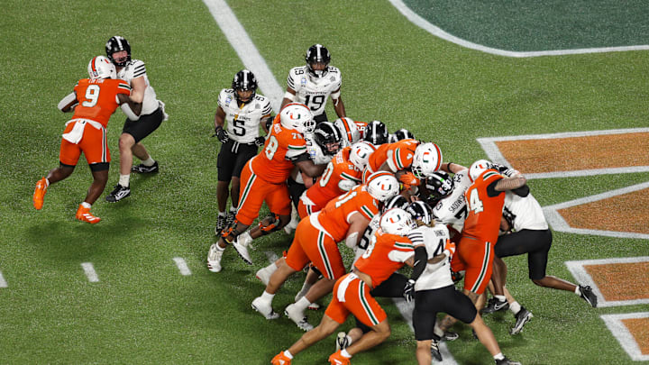 Dec 28, 2024; Orlando, FL, USA; Miami Hurricanes running back Mark Fletcher Jr. (4) scores a touchdown against the Iowa State Cyclones in the third quarter during the Pop Tarts bowl at Camping World Stadium. Mandatory Credit: Nathan Ray Seebeck-Imagn Images