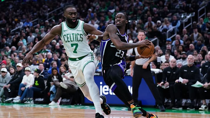 Jan 10, 2025; Boston, Massachusetts, USA; Sacramento Kings guard Keon Ellis (23) drives the ball against Boston Celtics guard Jaylen Brown (7) in the second quarter at TD Garden. Mandatory Credit: David Butler II-Imagn Images