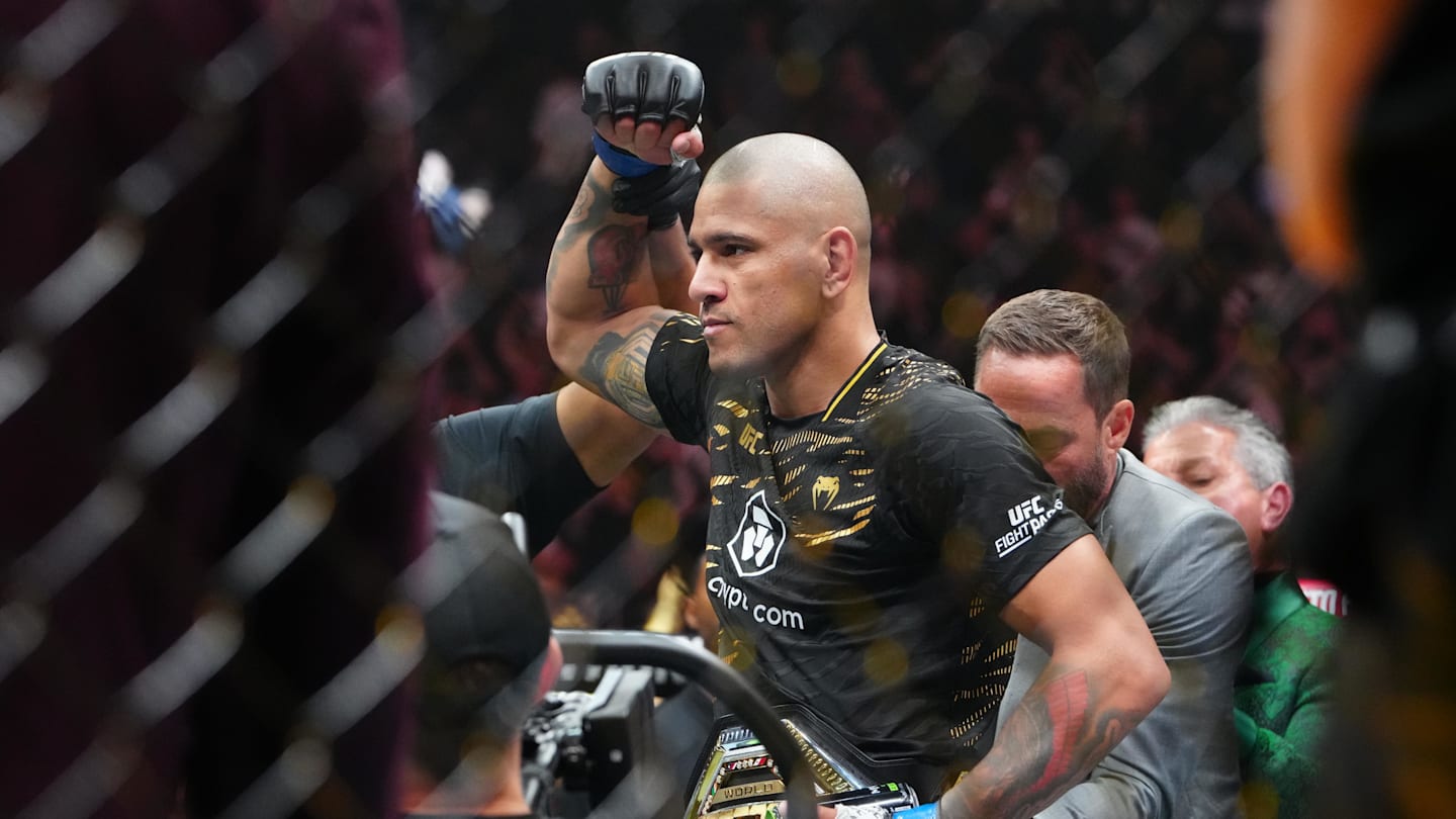 Alex Pereira (blue gloves) reacts after the fight against Magomed Ankalaev (red gloves).