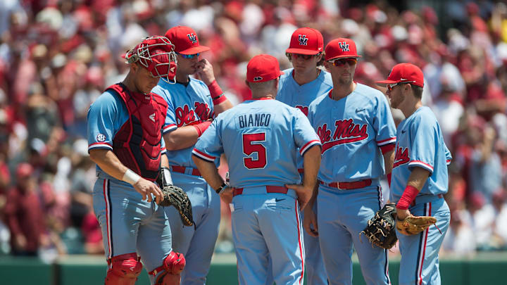 Jun 8, 2019; Fayetteville, AR, USA; Mississippi Rebels head coach Mike Bianco (5) talks with his players while making a pitching change during the game against the Arkansas Razorbacks at Baum-Walker Stadium. Mandatory Credit: Brett Rojo-Imagn Images