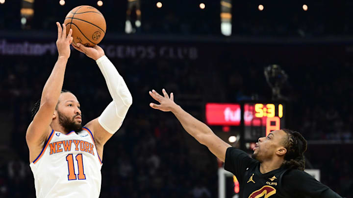 Feb 21, 2025; Cleveland, Ohio, USA;  New York Knicks guard Jalen Brunson (11) shoots over the defense of  Cleveland Cavaliers guard Darius Garland (10) during the first half at Rocket Arena. Mandatory Credit: Ken Blaze-Imagn Images
