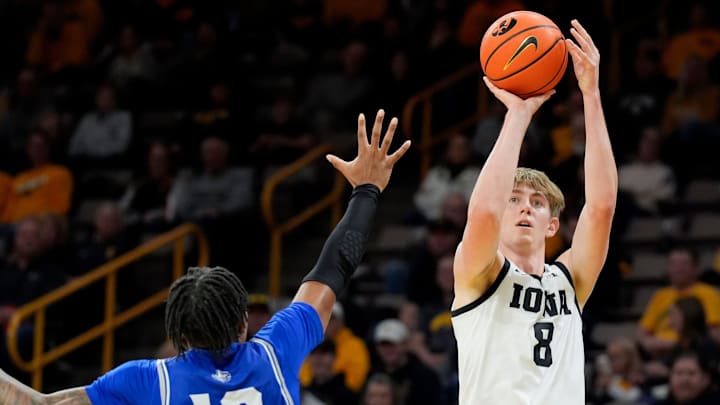 New Orleans Privateers guard Jamond Vincent (13) defends a shot attempt by Iowa Hawkeyes forward Cooper Koch (8) Sunday, Dec. 15, 2024 at Carver-Hawkeye Arena in Iowa City, Iowa.