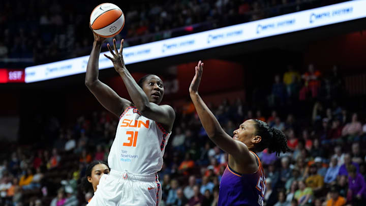 Sep 6, 2025; Uncasville, Connecticut, USA; Connecticut Sun center Tina Charles (31) shoots against Phoenix Mercury forward Alyssa Thomas (25) in the first half at Mohegan Sun Arena. David Butler II-Imagn Images