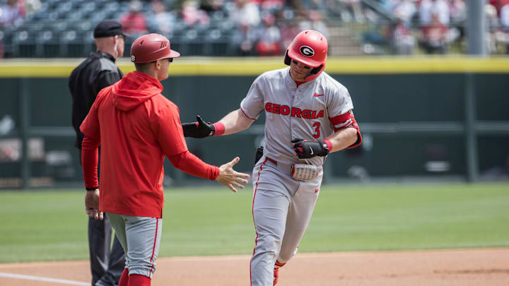 Apr 18, 2026; Fayetteville, AR, USA;  Georgia Bulldogs catcher Daniel Jackson (3) rounds third base after a solo home run and slaps hands with third base coach Brock Bennett during the first inning against the Arkansas Razorbacks at Baum-Walker Stadium. Georgia won 26-14. Mandatory Credit: Brett Rojo-Imagn Images