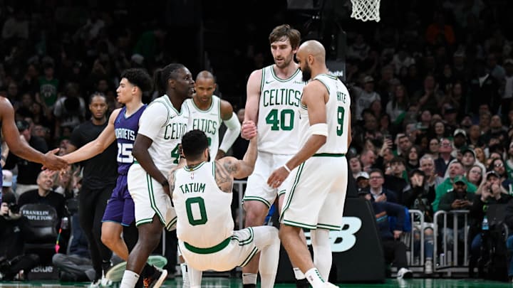 Apr 11, 2025; Boston, Massachusetts, USA; Boston Celtics guard Jrue Holiday (4) and .center Luke Kornet (40) help forward Jayson Tatum (0) to his feet during the second half against the Charlotte Hornets at TD Garden. Mandatory Credit: Eric Canha-Imagn Images