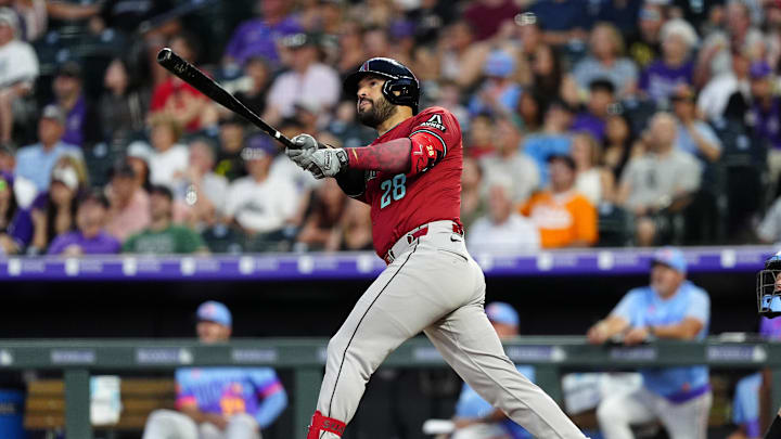 Jun 20, 2025; Denver, Colorado, USA; Arizona Diamondbacks third baseman Eugenio Suarez (28) hits a two run home run in the sixth inning against the Colorado Rockies at Coors Field. Mandatory Credit: Ron Chenoy-Imagn Images